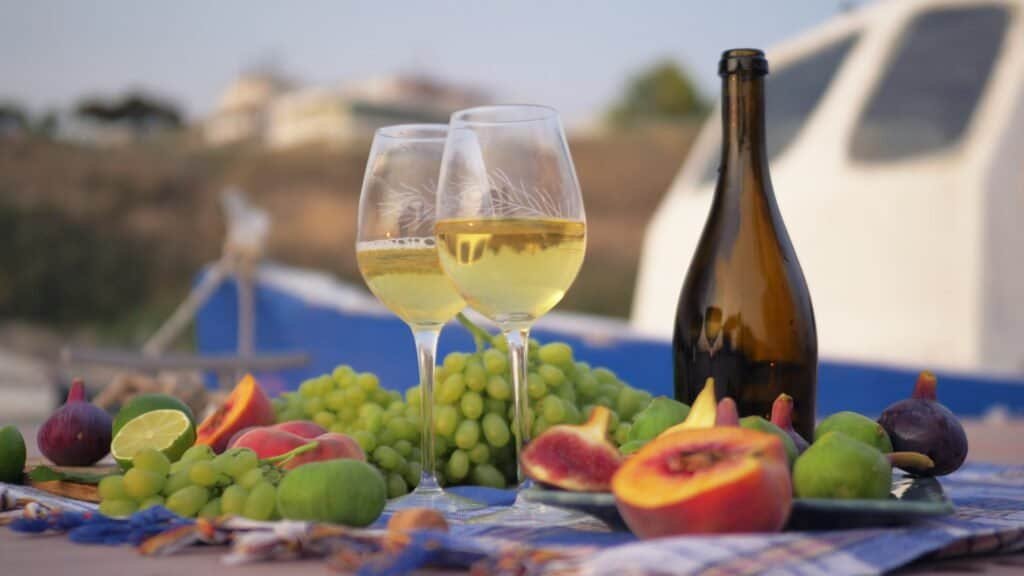 Wine and fresh fruit by the sea